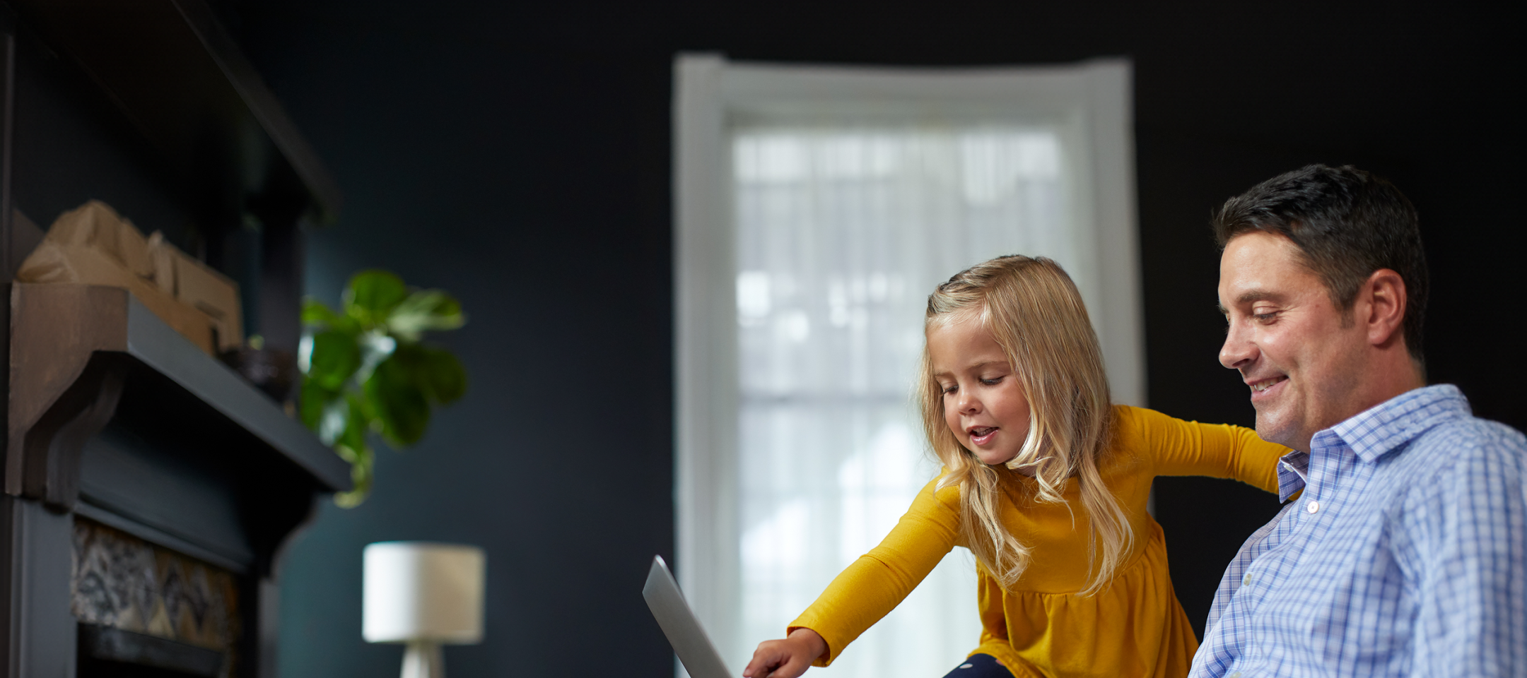Father and Daughter Pointing to Laptop