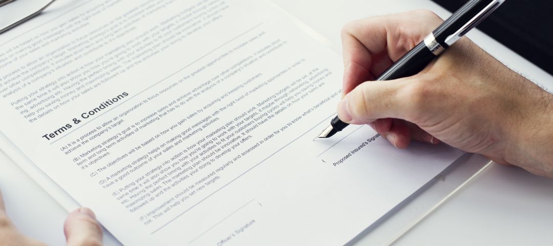 Closeup Hand Signing Paperwork