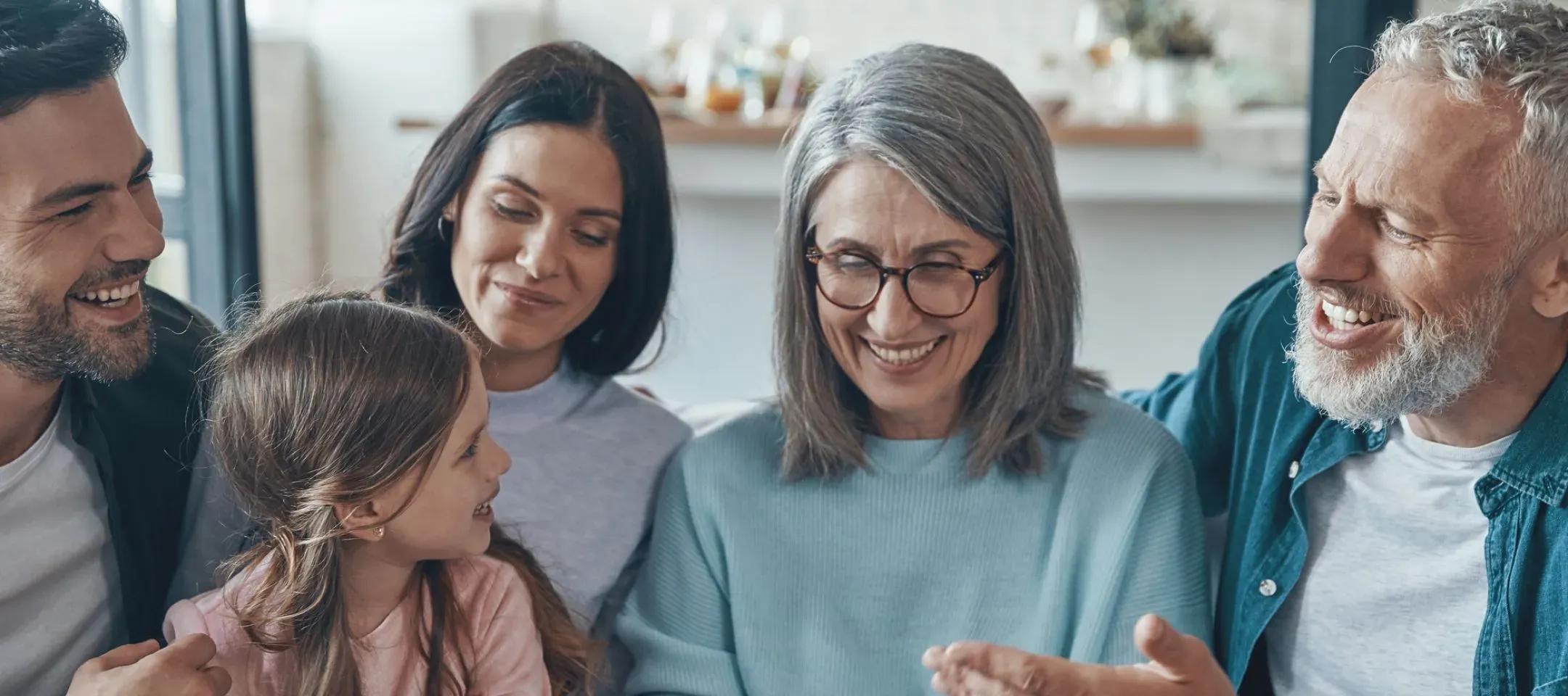 WTC Communications Kingston - Happy family with child and grandparents enjoying fast fibre internet connected through their smart home network.