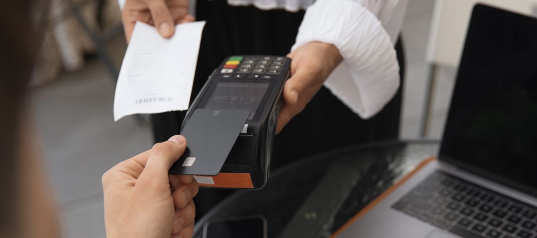 Customer Paying with POS Machine at Table