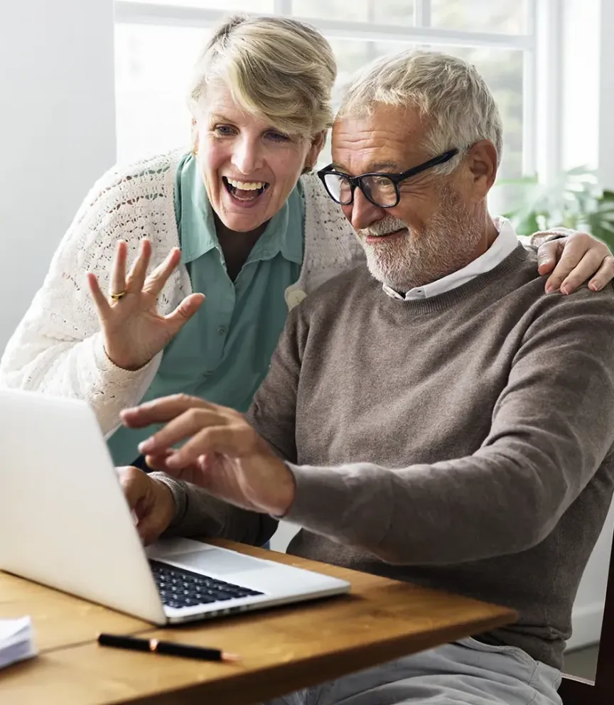 WTC Communications Amherstview - Happy senior couple enjoying a video call on their laptop, connecting with loved ones.