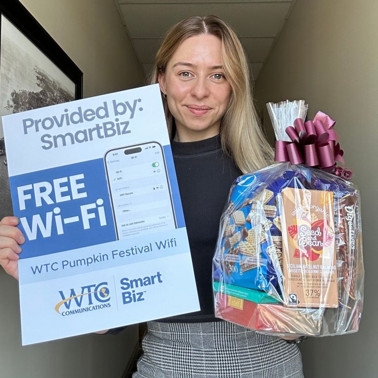 Catharine holding SmartBiz Poster