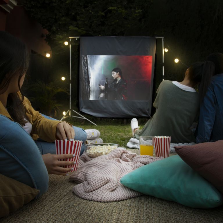 Watching projector show in backyard movie outdoors
